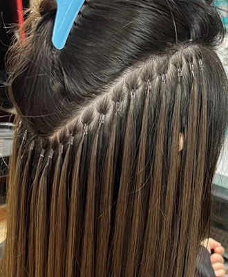 Woman getting micro link extensions